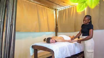 Experience rejuvenation in this serene massage therapy room, featuring a massage table and a comfortable bench.
