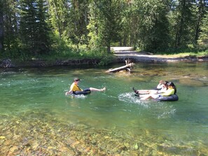 A river with clear water, surrounded by trees. - Historic Family Style Homestead Cabin (Condon)