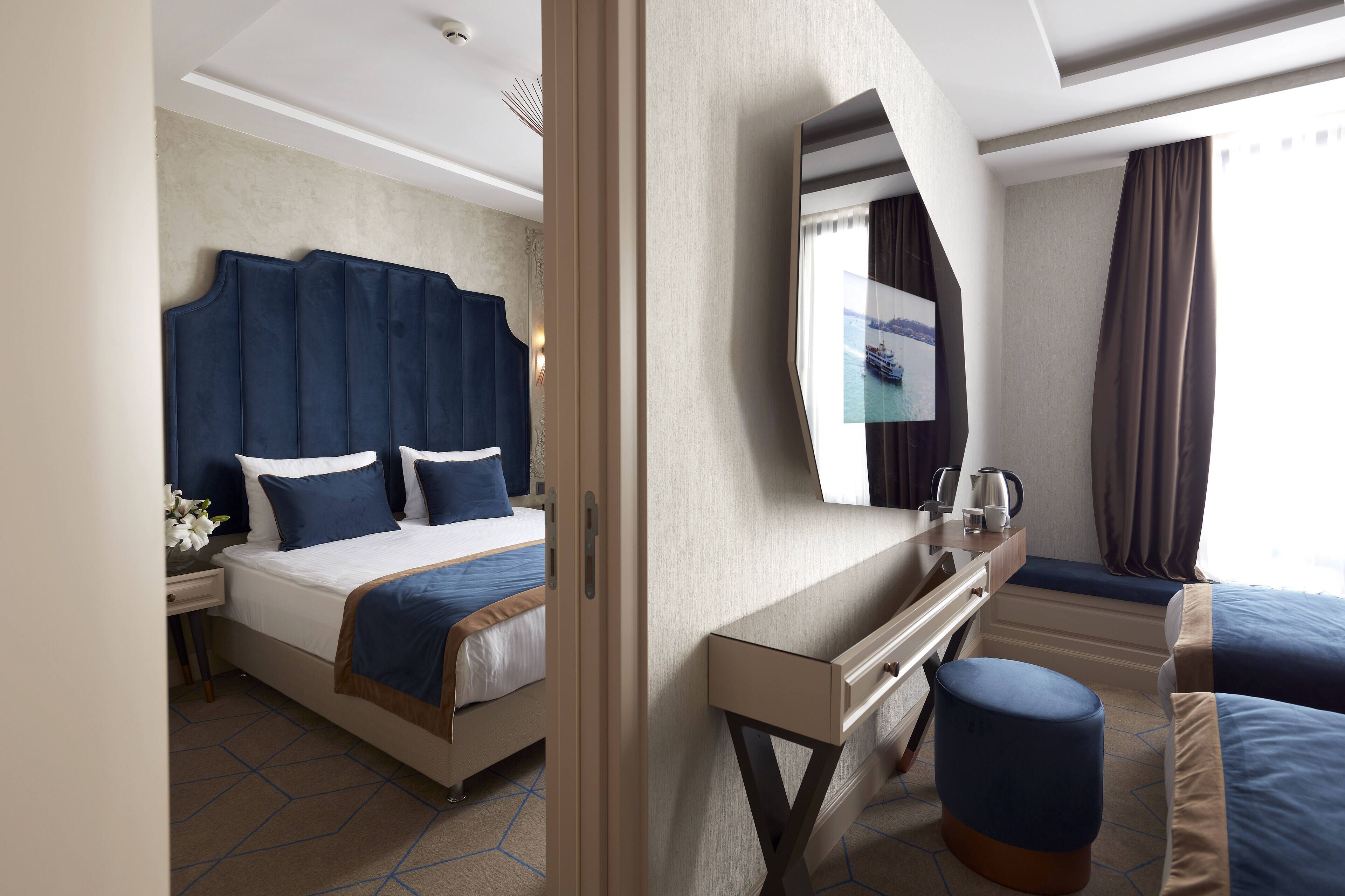 deluxe quadruple room | premium bedding, minibar, in-room safe, desk