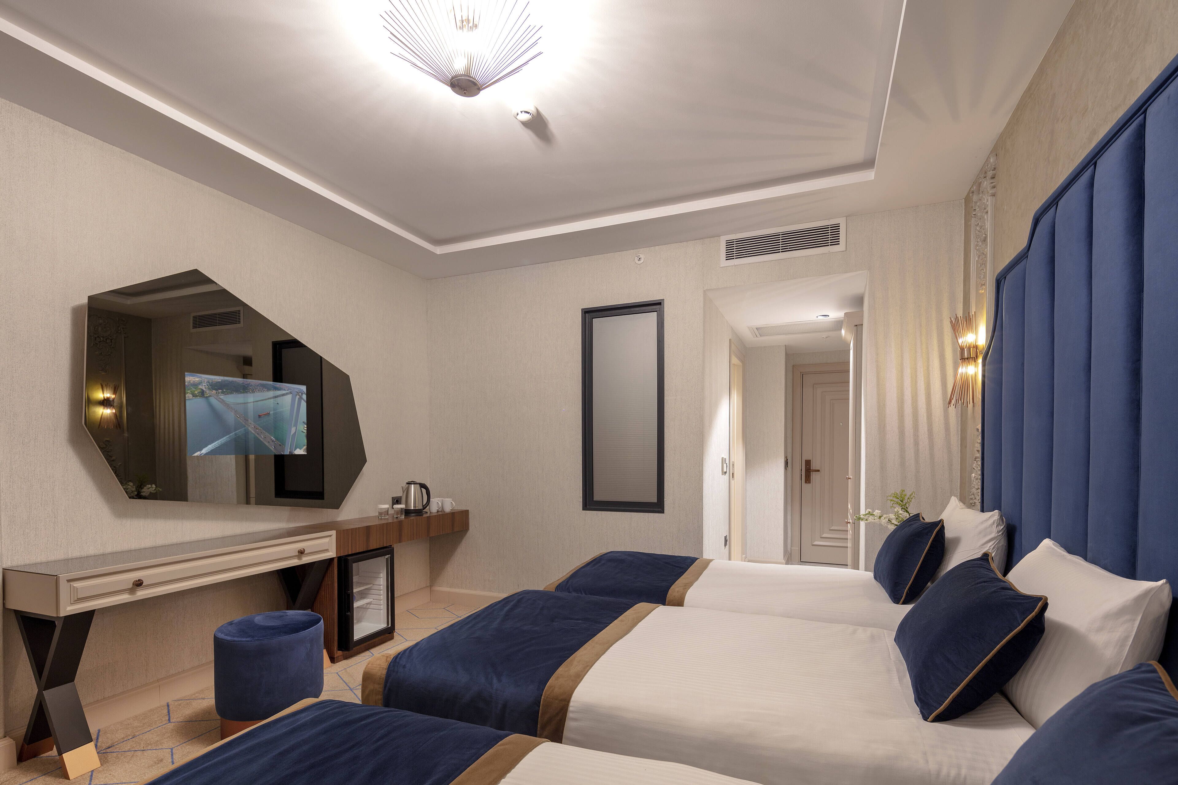 deluxe triple room | premium bedding, minibar, in-room safe, desk