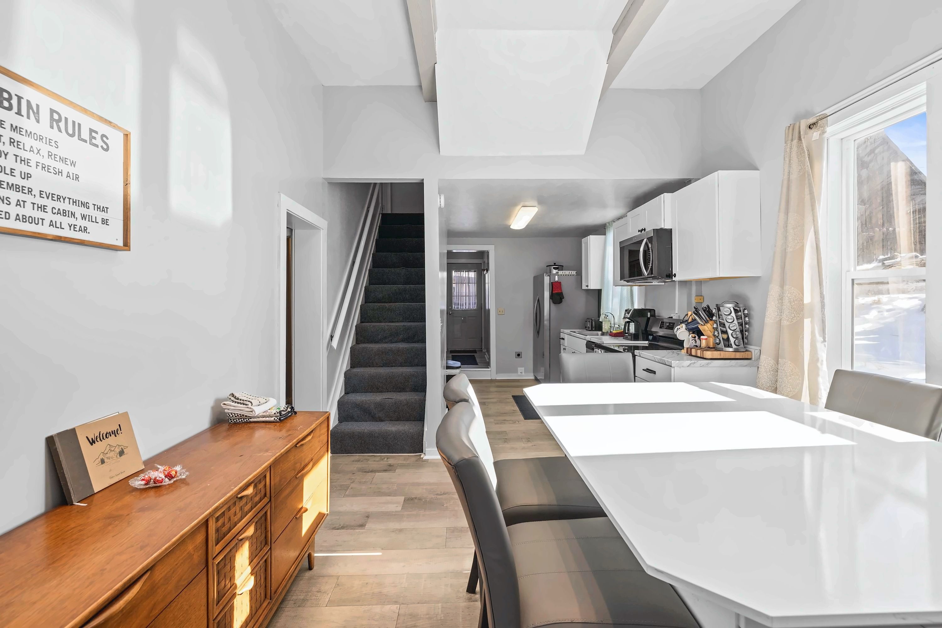 【Main Floor】 The staircase leads to all upstairs bedrooms — kitchen is straight ahead.