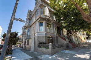 A Victorian-style building with a prominent bay window, a stone facade, and a staircase leading to the entrance. - Fabulous Classic Victorian Home in Pacific Heights (San Francisco)
