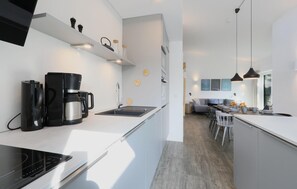 Enjoy cooking and dining in this stylish kitchen with a stovetop and sleek appliances.