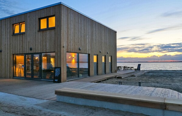 Situated on a sandy beach, this two-story building offers a cafe, kitchen, and drinks.