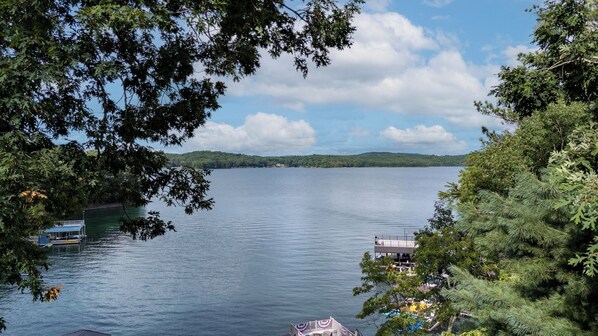 A lake with docked boats, a pier, and surrounding trees. - When in Rome - Lake Blue Ridge (Blue Ridge)
