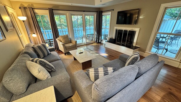 A living room with a gray sectional sofa, a coffee table, and a fireplace.