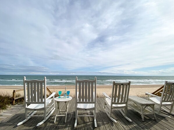 Guests can enjoy a drink on the deck with ocean views.