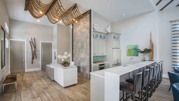 A modern kitchen with a central island, bar stools, and a hanging light fixture. - Veranda Palms 8 Bedroom Home with Pool(2208) (Kissimmee)