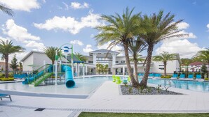 A swimming pool area with a water slide, lounge chairs, and palm trees. - Veranda Palms 8 Bedroom Home with Pool(2208) (Kissimmee)