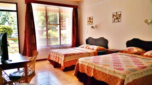 A hotel room with two beds, a desk, and a chair. - Divisamar Manuel Antonio, A natural paradise for you. (Quepos)