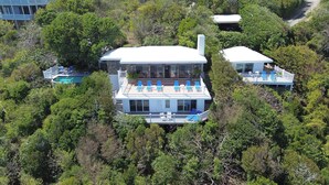 A large house with a pool, multiple decks, and a lush surrounding. - Caribbean Cottage with Breathtaking Views and Your Own Private Pool! (Cruz Bay)