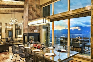 Enjoy meals with a view of the surrounding mountains from this dining area, featuring a large table and comfortable seating for six.