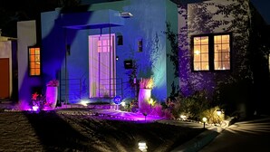 A house with a blue facade, a front door, and a small porch area with potted plants. - Private house in a safe area, close to Nob Hill, UNM, Airport, Netflix, and KAFB (Albuquerque)