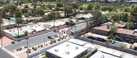 A residential area with multiple apartment buildings, a parking lot, and a road.