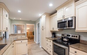 Enjoy cooking in this well-equipped kitchen with a gas stove, oven, and microwave.