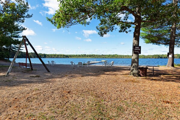 Relax by the serene lake with a beach, perfect for families or groups to unwind.