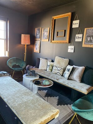 Relax in a comfortable living space with a plush sofa, matching bench, and stylish armchair.