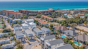 A coastal residential area with houses, a swimming pool, and a view of the ocean. - Private Pool ~ Golf Cart ~ Walk to the Beach (Miramar Beach)