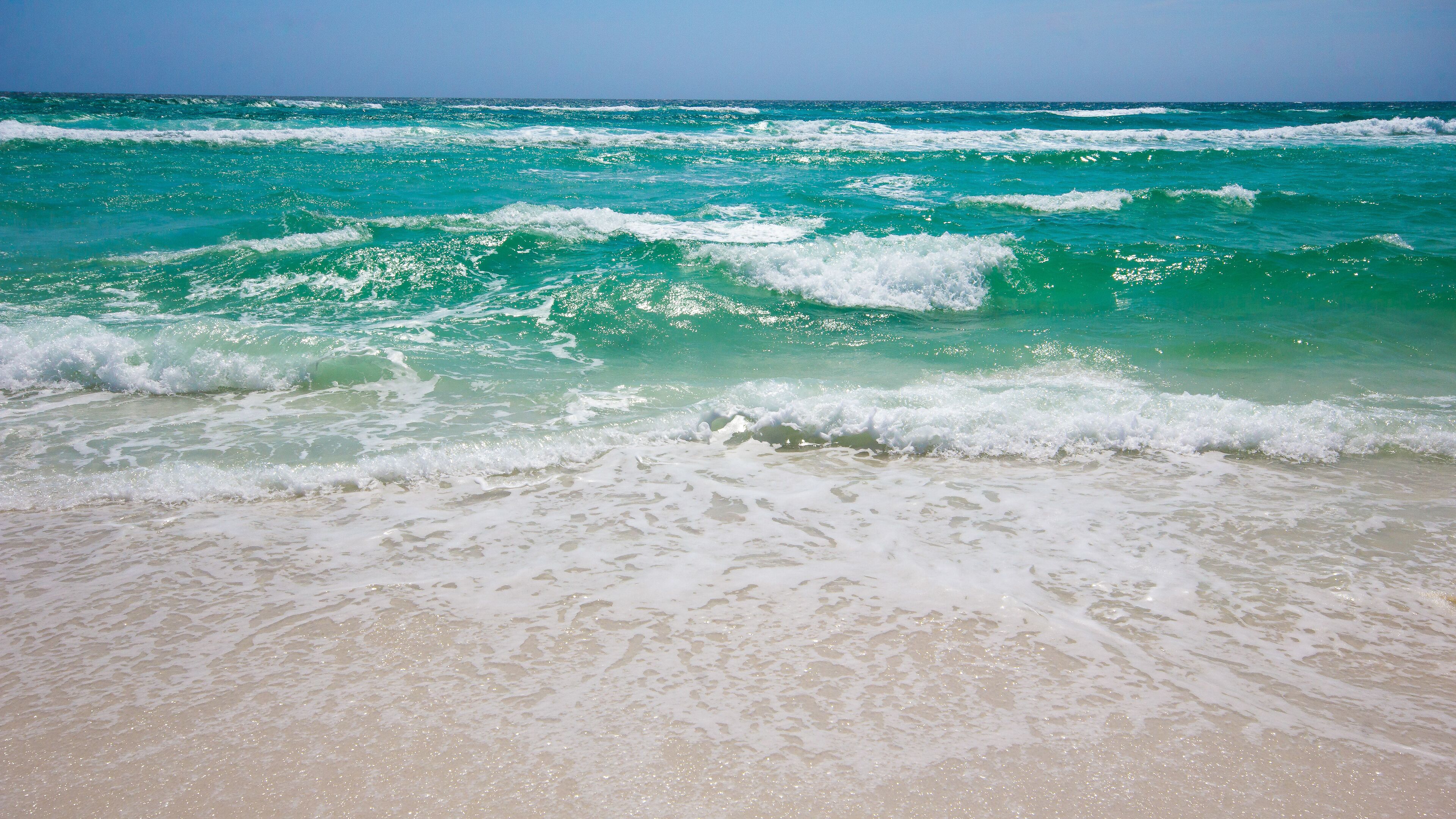 Una playa con olas rompiendo sobre la orilla.
