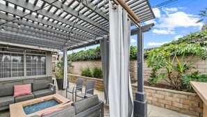 A covered patio with a seating area, a small pool, and a pergola with string lights. - Beautiful house to relax and enjoy close to Camarillo outlets and beach (Camarillo)