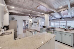 Enjoy cooking in this well-equipped kitchen with a central island, sink, and stovetop.