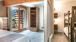 A bedroom with a bed, a wardrobe, and a radiator. - 800m des Remontées ! Appart Rustique + Sauna (Gresse en Vercors)