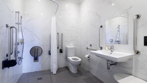 A modern bathroom with a shower, toilet, and sink. - A lews castle that sleeps 2 guests  in 1 bedroom (Isle of Lewis)