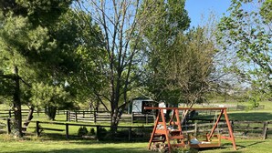 A circular seating area with Adirondack chairs around a fire pit, surrounded by a gravel border. - Raven Fox Farm-Country Charm! 5 BR Only 8 miles from Keeneland and BG Airport (Versailles)