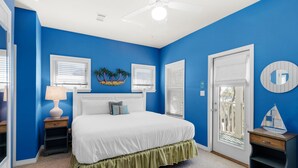 A bedroom with a white bed, blue walls, a ceiling fan, and a window with blinds. - ☀️Bikes-Pools-30A-Close to Beach-Chihuahua Flats (Santa Rosa Beach)