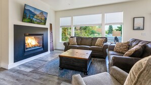 A living room with a fireplace, a sofa set, and a coffee table. - Brand new incredible Columbia Falls home - Flathead river walking trail - A/C for hot summer days (Columbia Falls)