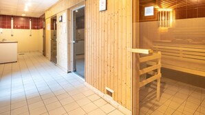 A sauna area with wooden walls and a bench.