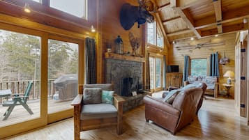 Télévision, cheminée, lecteur de DVD, baby-foot