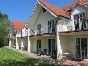 Enjoy the tranquil atmosphere of this two-story residence with a balcony and garden.