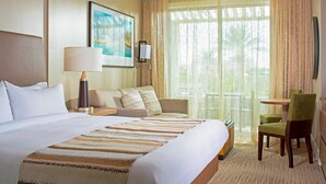 A hotel room with a large bed, a sofa, a desk, and a chair. There is a window with curtains, a painting on the wall, and a lamp. - Marriott Canyon Villas - Two Bedrooms-Direct from Owner  (Phoenix)
