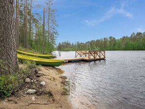 A lakeside dock with canoes and a wooden pier.
