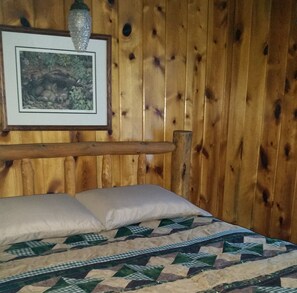 Relax in this charming room with a comfortable bed and a framed picture above.