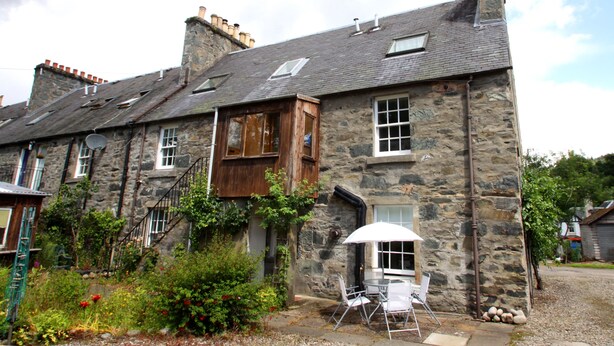 A stone building with a wooden extension, a staircase, and a patio with outdoor seating. - The Wee Nook, Birnam & Dunkeld (Birnam)