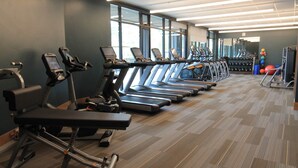 A gym with multiple treadmills, exercise bikes, and weights. - The Premier Ski-in Ski-out Address in all of Colorado - Unit LIcense 81047001. (Breckenridge)