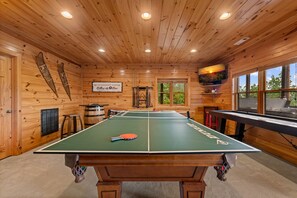 A billiards table in a wooden room with a sign for Blackberry Lodge Billiards & Bar. - Blackberry Lodge- Pet Friendly | Outdoor Firepit | Hot Tub (Blue Ridge)