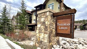 Een stenen pilaar met een bord voor Trailhead Lodges.