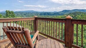 A wooden deck with a view of green mountains. - MTN VIEWS! True Mtn Wood Cabin-Pool Tble-6x parking-main level master-wifi (Sevierville)