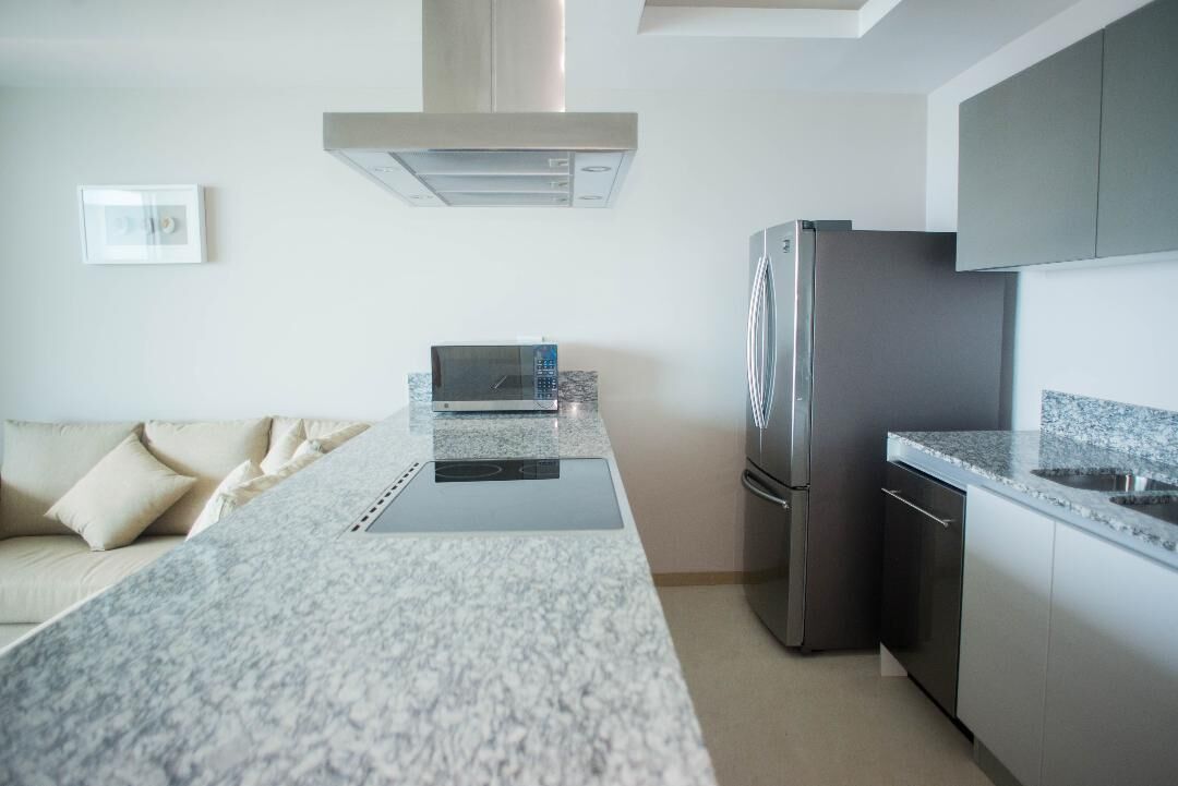 A modern kitchen with a built-in stove, stainless steel appliances, and a granite countertop.