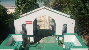 A staircase leading to a beach house with a view of the ocean. - Hideaway  by the Sea (Montego Bay)