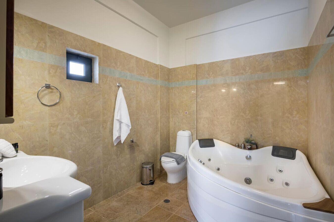 A bathroom with a bathtub, a toilet, and a sink.