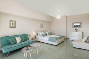 A modern bedroom with a bed, a sofa, a dresser, and two small tables. - Luxury villa near Beach, with Private Pool & Views (Chania)