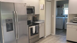 A modern kitchen with stainless steel appliances, a microwave, oven, and dishwasher. - 3 bed/3 bath with Stunning Lakeview from private pool (Rotonda West)