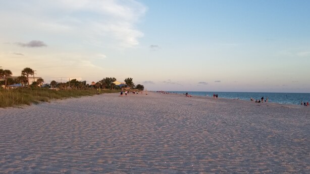 A wide sandy beach with people walking and relaxing. - 3 bed/3 bath with Stunning Lakeview from private pool (Rotonda West)