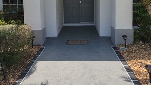 A house with a grey door, a white facade, and a small porch area. - 3 bed/3 bath with Stunning Lakeview from private pool (Rotonda West)