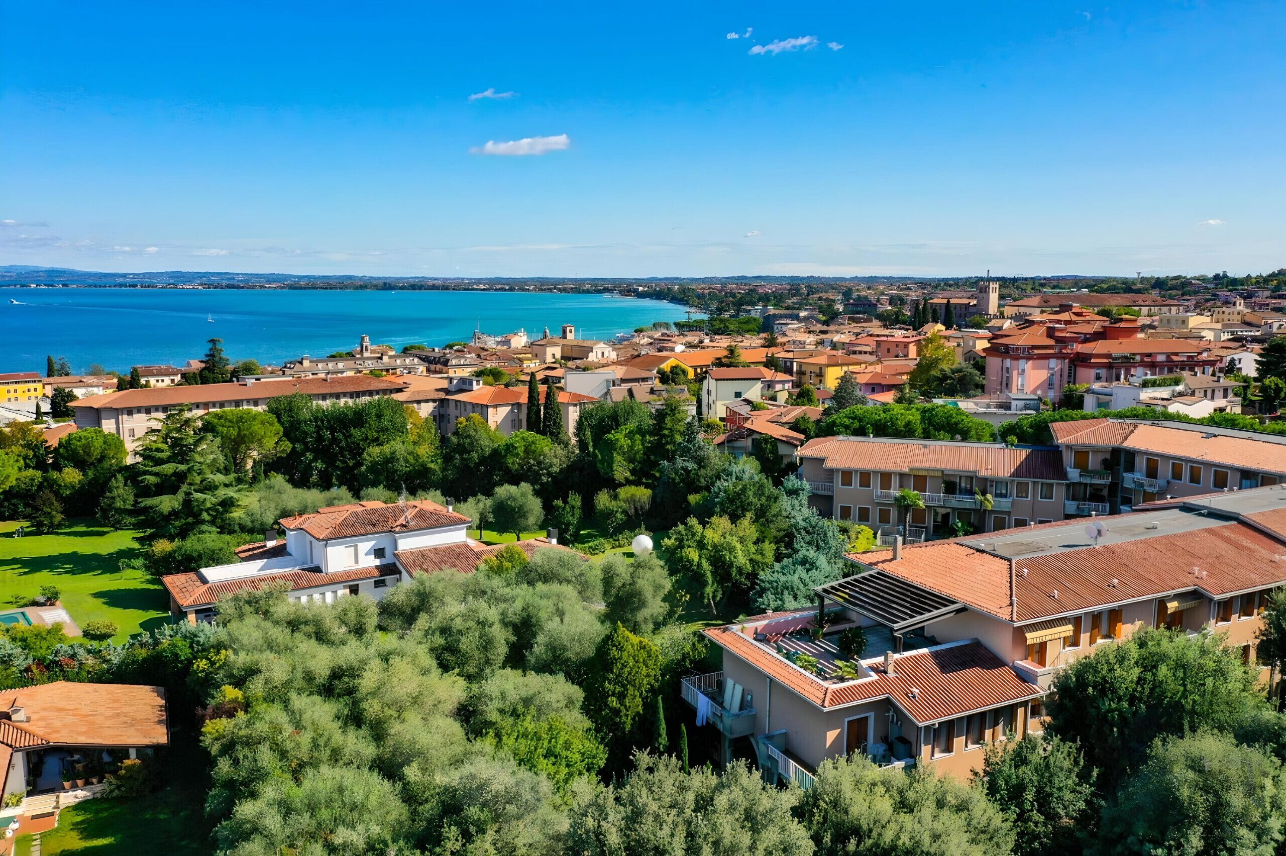 A coastal town with a mix of residential buildings and a prominent church tower.
