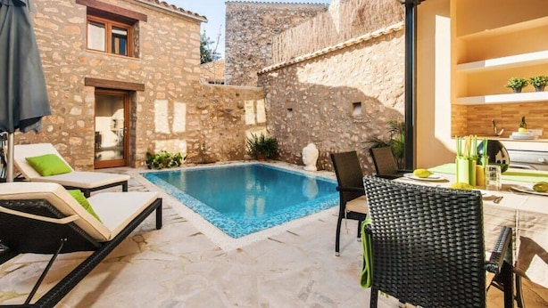 A stone building with a pool, lounge chairs, and a dining area. - Can Bodeguita, Wifi, Private pool and terrace. (Binissalem)